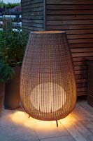 Outdoor lamp made of plastic mesh in a modern garden 