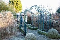 Garden with rose arches in winter 