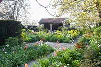 Country garden with arbor in spring 