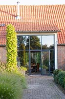 Garden with beech columns at the entrance, Carpinus betulus 