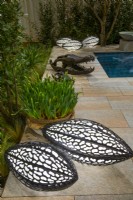 Bright luminescent, handmade decorative lamps made of brass. House inspired by nature and an African, crocodile sculpture on the edge of the pool.
Designer: Vetschpartner, Berger Gartenbau and Livingdreams. Giardina-Zurich, Swiss. 


 
