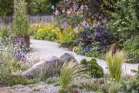 Stipa tenuissima in drought tolerant area. RHS Iconic Horticultural Hero Garden, Designer: Carol Klein, RHS Hampton Court Palace Garden Festival 2023