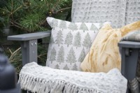 Cushions and blanket on recycled plastic chair