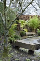 Wooden benches in Sybil's Garden at York Gate in February