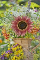 Summer bouquet containing wildflowers and a sunflower.