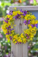 Yellow - purple wreath made of fennel, heal-all and birdsfoot trefoil.
