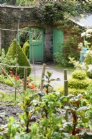 Green painted gate in the walled garden at Hartland Abbey in April