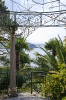 Classical style ornate metal temple with a view towards the St Mawes Harbour, hardy palms surround in this semi tropical garden