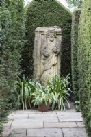 Sculpture of Henry II in the Ashton Arbour. Hedges of clipped Yew. April. Spring.