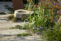 Stack bonded paving made from stone offcut setts with waste material gravel showcasing sustainable garden construction. It Doesn't Have To Cost The Earth, RHS Malvern Spring Festival 2024. Design: Micael Lote